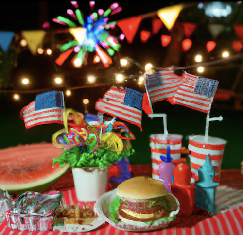 4th of July Party Image with hamburger, watermelon, US flags and fireworks.