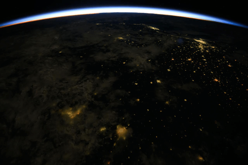 ss072e340644 (Nov., 18, 2024) --- An orbital sunrise crowns Earth's horizon in this photograph from the International Space Station as it orbited 261 miles above Brazil. At top right, the city lights of Rio de Janiero and Sao Paulo on the Atlantic coast are visible from the orbital outpost.